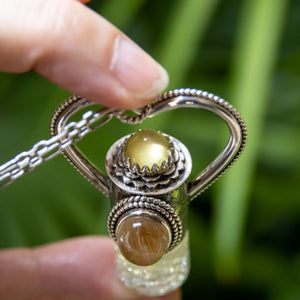 Fountain Sunset Rollerball Necklace Series - Amber & Yellow Rutilated Quartz on Black Leaf Pattern